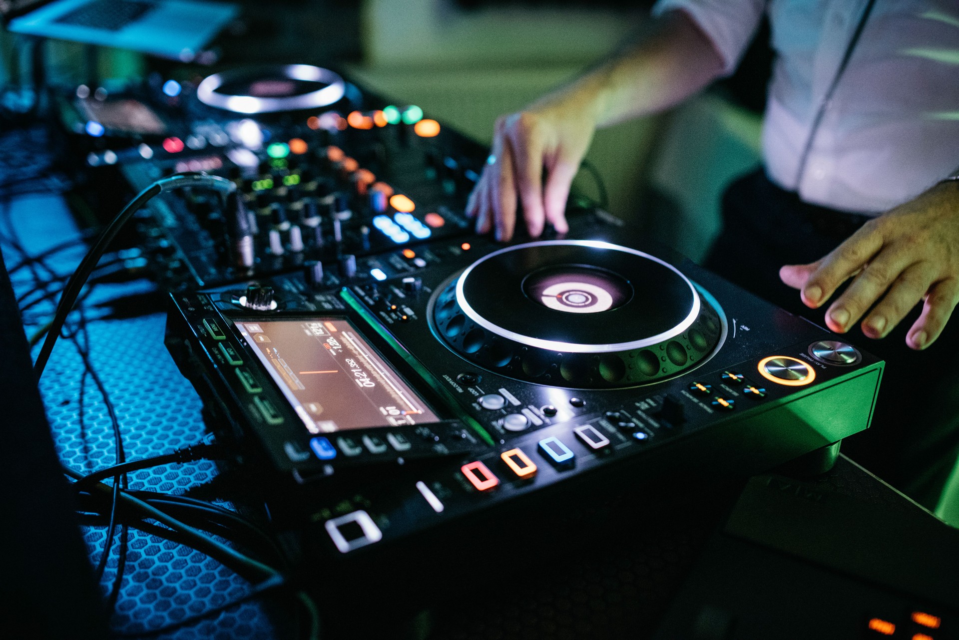 Professional DJ Equipment at Nightclub with Colorful Illumination